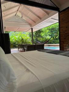 a bedroom with a large white bed and a patio at Juntas Del Lago in Apulo +89 photos