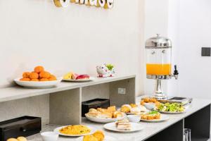a buffet with plates of food on a counter at The Muse Hotel 1 in Ðố Sơn