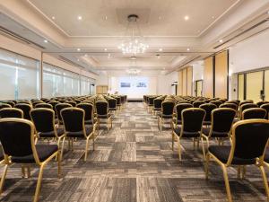 an empty room with chairs and a projection screen at Sofitel Lyon Bellecour in Lyon
