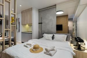 a bedroom with a large white bed with towels on it at Beach Bliss std in Infinity Pool & Spa Resort in Năvodari