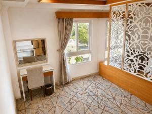a home office with a desk and a window at Tây Nam 2 Hotel in Can Tho