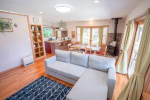a living room with a white couch and a kitchen at Star Peak Villa 黒川 in Minamioguni +89 photos