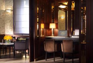 a bar in a room with chairs and a table at Splendid Etoile in Paris