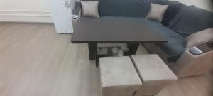 a living room with a table and a couch at Hakim Karim Apartments in Khujand