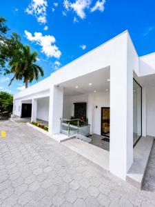 a white building with a blue sky in the background at Hotel Arkam in San Salvador