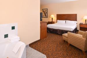 a hotel room with a bed and a chair at Holiday Inn Express Morgantown, an IHG Hotel in Morgantown