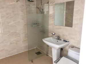 a bathroom with a sink and a glass shower at popcorn hostel haeundae in Ch'ŏngsap'o