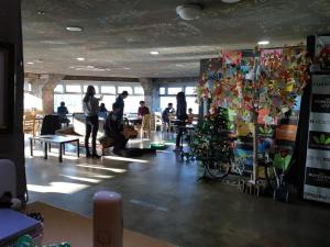 a group of people in a room with a christmas tree at popcorn hostel haeundae in Ch'ŏngsap'o