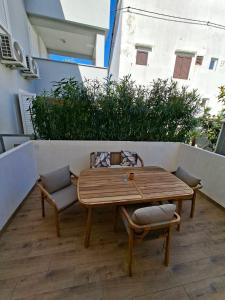 a wooden table and chairs on a patio at Vacation home Dora in Baška