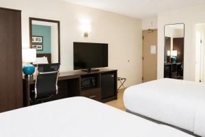 a hotel room with two beds and a flat screen tv at Sleep Inn Staunton in Staunton
