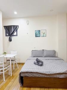 a bedroom with a bed with a teddy bear on it at ROSE Appartment in Ho Chi Minh City