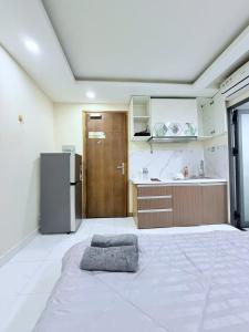 a large kitchen with a refrigerator and a counter at ROSE Appartment in Ho Chi Minh City