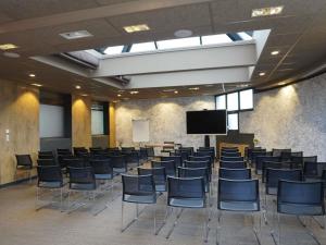 a conference room with chairs and a tv in it at ibis Valence Sud in Valence +169 photos