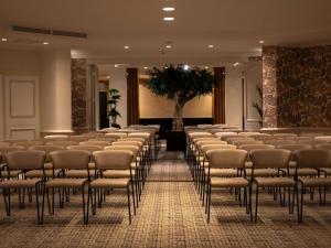 a room with rows of chairs in a building at Sofitel Le Scribe Paris Opera in Paris