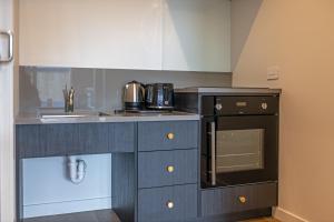 a small kitchen with a sink and a stove at The Stables Motel in Bulls +17 photos