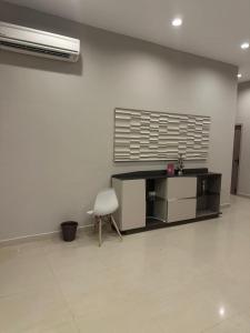 a white room with a desk and a chair at King Residency in Chennai