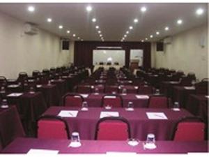 a large room with purple tables and chairs at Sea Front Hotel Port Dickson in Port Dickson