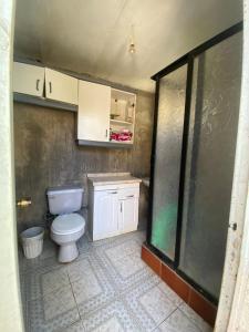 a bathroom with a white toilet in a room at Spacious Beach House with Pool for Relaxing in El Quisco +8 photos