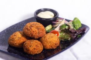 a plate of food with meatballs and a salad at Kilian's Lodge Hotel in Mullagh