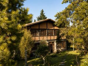 a large house with trees in front of it at Chalet Ojo de Agua in Jilotepec de Abasolo