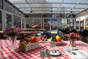 a table with fruits and vegetables on a checkered table cloth at Daecheon jeulgeoun pension in Boryeong