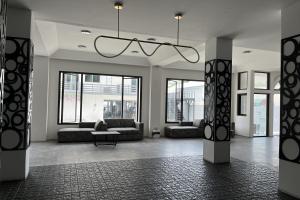 a large living room with couches and a chandelier at VS Beach Front in Jomtien Beach