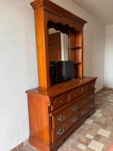 a wooden dresser with a television on top of it at Hotel Casa Don Marcos in Ixtafiayuca