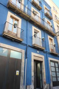 a building with two windows and a clock on the side of it at Pigal in Tarragona