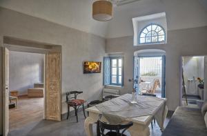 a dining room with a table and chairs in a room at 318 Oia Villa in Oia
