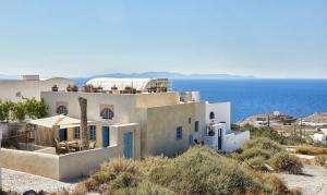 a white house with a view of the ocean at 318 Oia Villa in Oia