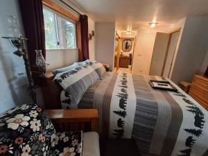 a small bedroom with two beds and a window at Hunter's Haven in Haines