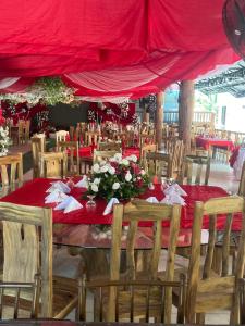 a table with a red table cloth and flowers on it at Palm Garden Resort in Carles +84 photos
