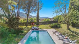 a swimming pool with lounge chairs and a swimming poolvisorvisor at Provencal Villa With Pool In Collobrières in Contre
