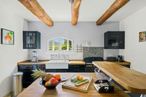 a kitchen with a table with a bowl of fruit on it at Provencal Villa With Pool In Collobrières in Contre