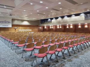 a conference room with chairs and a stage in the background at Novotel Athens in Athens +286 photos