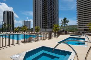 a swimming pool with a view of the city at Waikiki condo - ocean views, lanai & beach access in Honolulu +63 photos