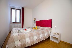a bedroom with a bed with a bowl of fruit on it at Appartamento Centro Storico Riva 2 - Happy Rentals in Riva del Garda