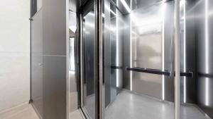 a hallway with a glass door in a building at Sokcho Sono Residence in Sokcho