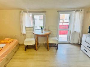 a small room with a table and two chairs at Room Nencheva in Sandanski