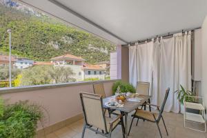 a dining room with a table and chairs on a balcony at Suite 22 - Happy Rentals in Riva del Garda