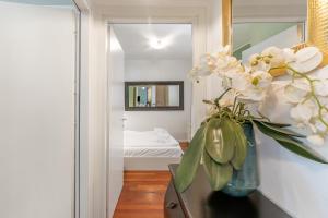 a vase of flowers on a table in a room at Suite 22 - Happy Rentals in Riva del Garda +11 photos