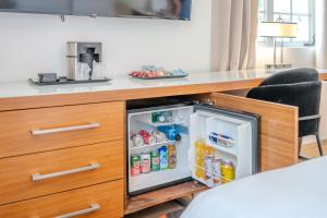 a kitchen with an open refrigerator underneath a desk at Hotel Harrison On the Beach in Miami Beach