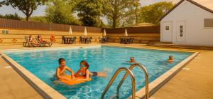 two women in the swimming pool at a hotel at Island Butterfly haven in Sandown