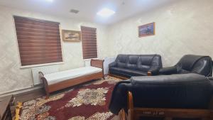 a living room with two couches and a couch at ADMIRAL in Termiz +29 photos