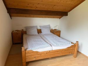 a wooden bed in a room with a wooden ceiling at Haus Eifeldolomiten - Ankommen und Wohlfühlen in Gerolstein