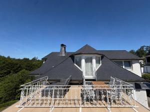 a house with a large deck with chairs on it at Timeout Apartment in Bad Arolsen