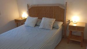 a bedroom with a bed with two night stands and two lights at Ca Isaak in Denia +19 photos
