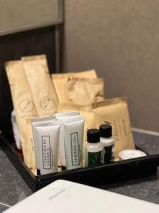 a tray with several bottles ofodorizers and paper bags at Adya Hotel Kuah Langkawi in Kuah