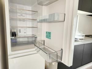 a white refrigerator with a clear glass door at seragaki blue twins 201 in Onna