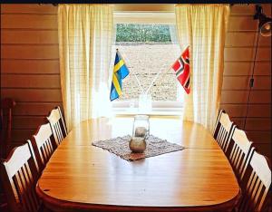 a dining room table with flags on top of it at Bakerstu in Skage i Namdalen